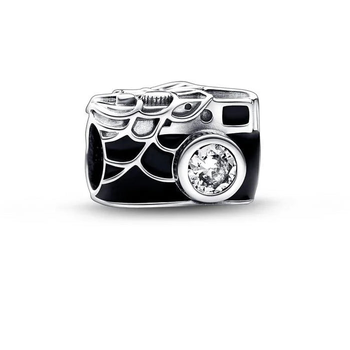 Camera-shaped charm with a diamond on a white background.