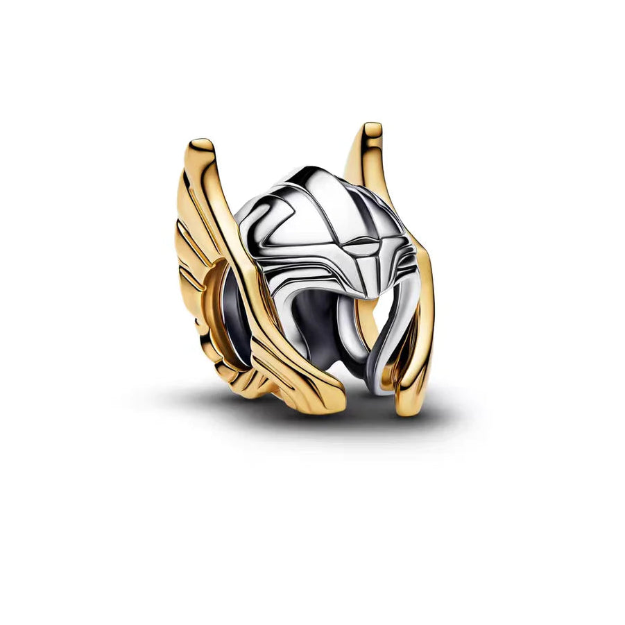 Gold and silver pendant with wings on a white background.